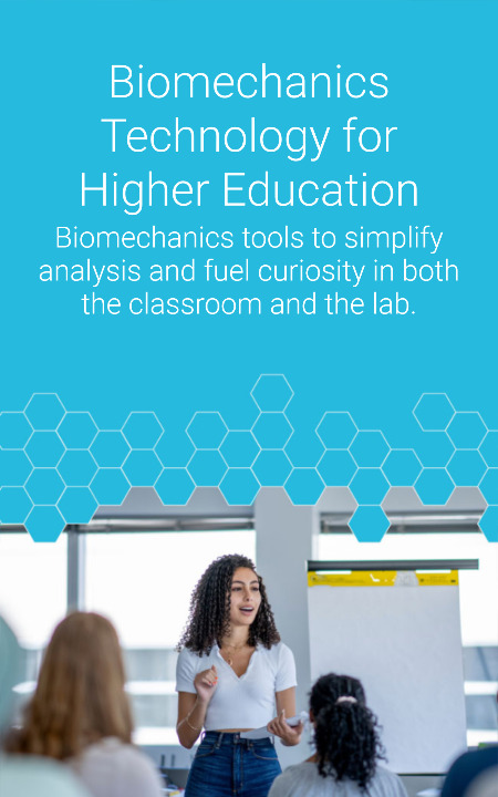 A woman is giving a presentation to a small group in front of a flipchart. The text reads, "Biomechanics Technology for Higher Education. Biomechanics tools to simplify analysis and fuel curiosity in both the classroom and the lab.