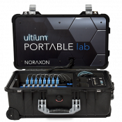 A black carrying case with an open lid showing electronic equipment inside. The lid display reads "Ultium PORTABLE lab NORAXON.